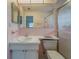 Retro bathroom features pink tiles, a spacious mirror, and a walk-in shower at 10005 41St N St, Pinellas Park, FL 33782