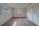 Bedroom featuring two windows, neutral carpet, and ample natural light at 10005 41St N St, Pinellas Park, FL 33782