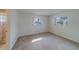 A simple bedroom, showing 2 windows and access to the ensuite bath with a shower at 10005 41St N St, Pinellas Park, FL 33782