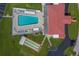 Aerial view of the community pool, shuffleboard court, and clubhouse at 10005 41St N St, Pinellas Park, FL 33782