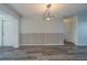 Spacious dining room with gray floors, bead board trim, and charming front door at 10005 41St N St, Pinellas Park, FL 33782