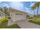 Garage and driveway showcasing a one-story home with a white exterior and decorative screen, complemented by a paved driveway at 10005 41St N St, Pinellas Park, FL 33782