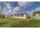 Exterior view of home showing side yard, patio and lawn at 10005 41St N St, Pinellas Park, FL 33782