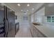 White tiled kitchen with stainless steel sink and black appliances at 10005 41St N St, Pinellas Park, FL 33782