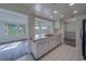 Bright kitchen with white cabinets, tile floors, and an open view to the living area at 10005 41St N St, Pinellas Park, FL 33782