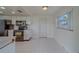 The eat-in kitchen features tile floors, modern black appliances and white cabinetry at 10005 41St N St, Pinellas Park, FL 33782