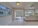 Eat-in kitchen with white cabinetry and easy access to the bright and airy living room at 10005 41St N St, Pinellas Park, FL 33782