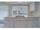 Kitchen with stainless steel sink, white cabinets, and view to an adjacent living space at 10005 41St N St, Pinellas Park, FL 33782