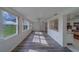 Well-lit living room featuring open access to kitchen and lovely gray floors at 10005 41St N St, Pinellas Park, FL 33782