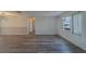 Bright living room showcasing wood-look flooring, neutral walls, and large windows, providing an open and airy feel at 10005 41St N St, Pinellas Park, FL 33782
