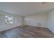Well-lit living room featuring wood-look flooring, neutral walls, and a view of the front yard, creating a cozy setting at 10005 41St N St, Pinellas Park, FL 33782