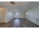 Open living room with wood-look flooring, neutral walls, and a view of the front door, creating a welcoming ambiance at 10005 41St N St, Pinellas Park, FL 33782