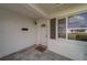Covered front porch with tiled floor, white door with glass accent, and side window, creating a welcoming entrance at 10005 41St N St, Pinellas Park, FL 33782