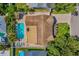 From above, the backyard features a pool, lush trees, and lounge chairs for peaceful outdoor living at 10339 111Th St, Largo, FL 33778
