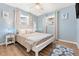 Well-lit bedroom features a white wood bed, two windows, with modern decor creating a relaxing atmosphere at 10339 111Th St, Largo, FL 33778