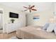 Comfortable bedroom features a TV, dresser, soft decor, and bright lighting to create a relaxing space at 10339 111Th St, Largo, FL 33778