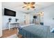 Bright bedroom featuring a ceiling fan, white desk, and a comfortable blue bed with lots of natural light at 10339 111Th St, Largo, FL 33778