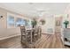 Bright dining room featuring a modern table set, natural light, and sleek wood flooring at 10339 111Th St, Largo, FL 33778