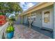 Welcoming front porch with a cozy seating area and decorative potted plants, offering curb appeal at 10339 111Th St, Largo, FL 33778