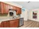 Kitchen sink with stainless steel dishwasher, cabinets, granite counters, and mosaic backsplash at 10339 111Th St, Largo, FL 33778