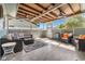 A covered patio with multiple seating areas and ceiling fans at 10339 111Th St, Largo, FL 33778