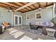 A covered patio with multiple seating areas and ceiling fans at 10339 111Th St, Largo, FL 33778
