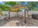 An outdoor pergola with a table and chairs and a grill at 10339 111Th St, Largo, FL 33778