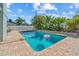 A large pool surrounded by a brick patio and tropical landscaping at 10339 111Th St, Largo, FL 33778