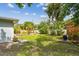 The expansive backyard features tropical foliage, a storage shed, and well-maintained landscaping at 11775 84Th Ave, Seminole, FL 33772