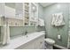 Cozy bathroom featuring a white vanity, mirror with shelves, and sage green walls at 11775 84Th Ave, Seminole, FL 33772