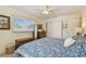 Cozy bedroom with blue floral bedding, dresser, and sliding closet doors with natural light at 11775 84Th Ave, Seminole, FL 33772