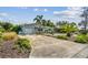 Landscaped front yard with palm trees and a concrete driveway leading to the garage at 11775 84Th Ave, Seminole, FL 33772