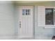 Bright white front door with glass paneling and stylish hardware against a clean exterior at 11775 84Th Ave, Seminole, FL 33772