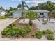 A beautiful home with tropical landscaping, rock gardens, and a well-maintained lawn at 11775 84Th Ave, Seminole, FL 33772