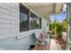 Cozy front porch featuring a white wicker bench and decorative tile flooring at 11775 84Th Ave, Seminole, FL 33772