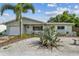 Charming single-story home with lush landscaping and a well-maintained exterior and manicured lawn at 11775 84Th Ave, Seminole, FL 33772