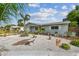 Charming single-story home featuring a well-manicured yard, complemented by tropical landscaping and bright exterior paint at 11775 84Th Ave, Seminole, FL 33772