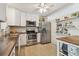Well-lit kitchen with stainless steel appliances, butcher block countertops, and sleek white cabinetry at 11775 84Th Ave, Seminole, FL 33772