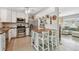 Well-lit kitchen features white cabinets, stainless steel appliances, and center island at 11775 84Th Ave, Seminole, FL 33772