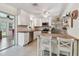 Bright kitchen with white cabinets, stainless steel appliances, and a central island with bar seating at 11775 84Th Ave, Seminole, FL 33772