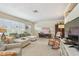 Inviting living room with a large window, cozy seating, and terrazzo floors at 11775 84Th Ave, Seminole, FL 33772