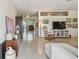 Open living room featuring polished terrazzo floors and seamless flow to other living spaces at 11775 84Th Ave, Seminole, FL 33772