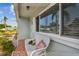 Comfortable front porch with tiled floors, cozy bench seating, and an inviting atmosphere at 11775 84Th Ave, Seminole, FL 33772