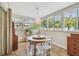 Bright sunroom with tiled floors and a dining area, bathed in natural light from surrounding windows at 11775 84Th Ave, Seminole, FL 33772