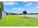 Expansive backyard featuring lush green grass and a tranquil lake view, perfect for relaxation and outdoor activities at 11785 Little River Way, Parrish, FL 34219