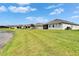 Lush backyard with a screened-in patio and a view of the lake, creating a serene outdoor oasis at 11785 Little River Way, Parrish, FL 34219