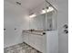 Bathroom features double vanity, large mirror, modern lighting, and tiled walk-in shower with glass partition at 11785 Little River Way, Parrish, FL 34219