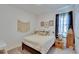 Cozy bedroom with white walls, macrame wall hanging, decorative pillows and patterned curtains at 11785 Little River Way, Parrish, FL 34219