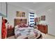 Comfortable themed bedroom featuring comic decorations, wood furniture, patchwork comforter, and striped curtains at 11785 Little River Way, Parrish, FL 34219