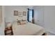 Cozy bedroom with a comfortable bed, decorative pillows, and a patterned curtain at 11785 Little River Way, Parrish, FL 34219